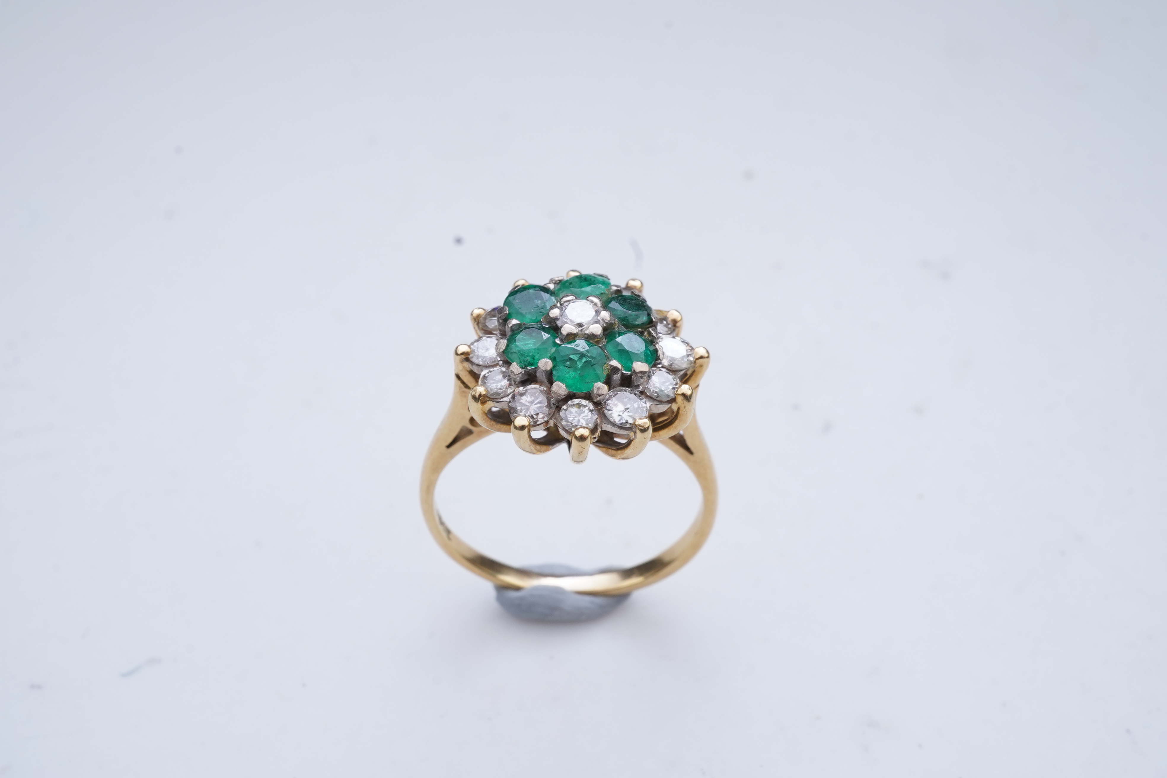 An emerald and diamond ring